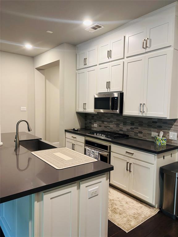 8223 Snapdragon Way Dallas, TX 75252 - Photo 17 of 32 Kitchen with white cabinetry, tasteful backsplash, stainless steel appliances, and recessed lighting