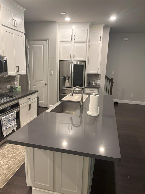 8223 Snapdragon Way Dallas, TX 75252 - Photo 3 of 32 Kitchen with tasteful backsplash, dark wood-style flooring, stainless steel appliances, white cabinetry, and recessed lighting