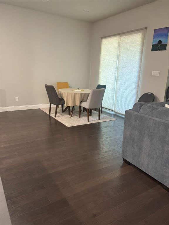8223 Snapdragon Way Dallas, TX 75252 - Photo 7 of 32 Dining area featuring dark wood-style flooring and baseboards