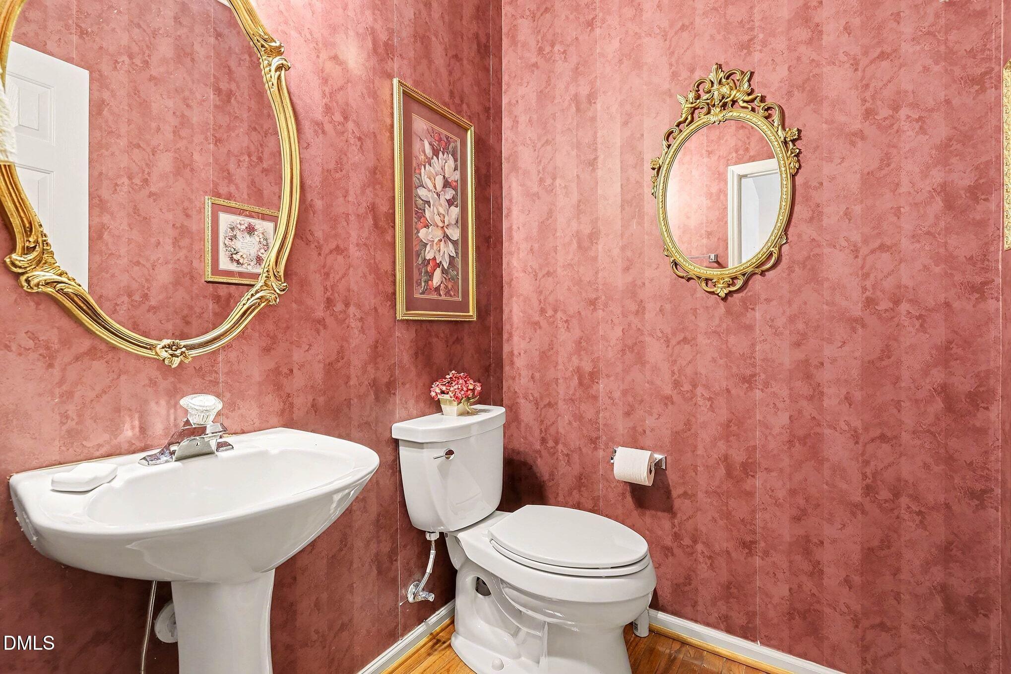 411 Latta Circle Durham, NC 27712 - Photo 22 of 36 a bathroom with a toilet sink and mirror