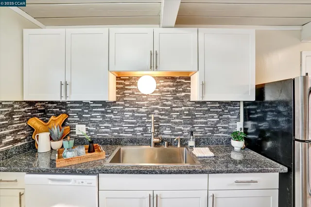 a kitchen with a sink and a refrigerator