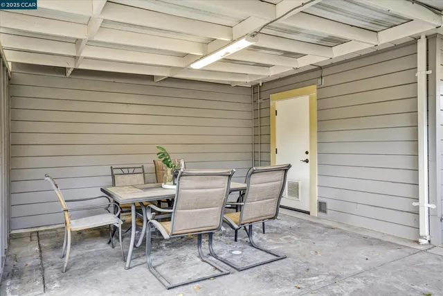 a view of a yard in front of a house with large tree