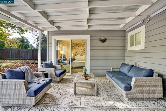 a backyard of a house with table and chairs