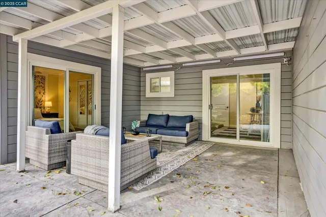 a front view of a house with a yard and potted plants
