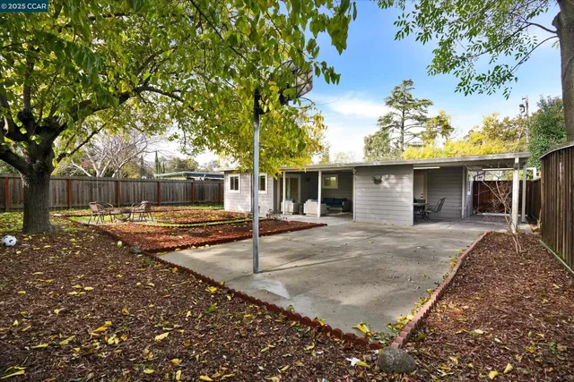 a view of backyard with a table and chairs