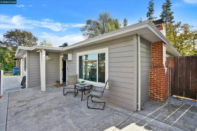 a view of a patio with table and chairs and potted plants