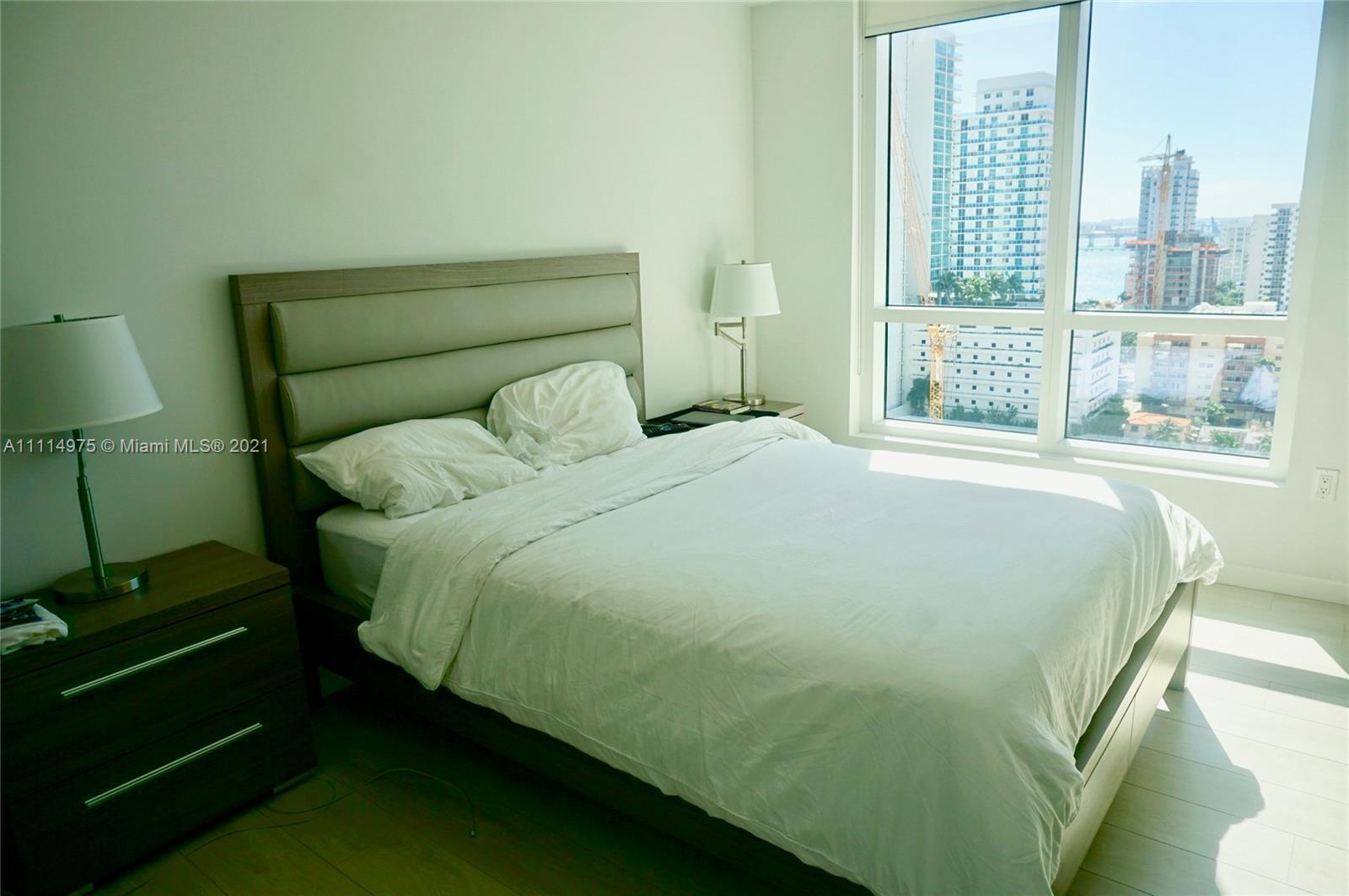 601 Northeast 27th Street, Unit 1604 Miami, FL 33137 - Photo 14 of 47 a bed sitting in a bedroom next to a window