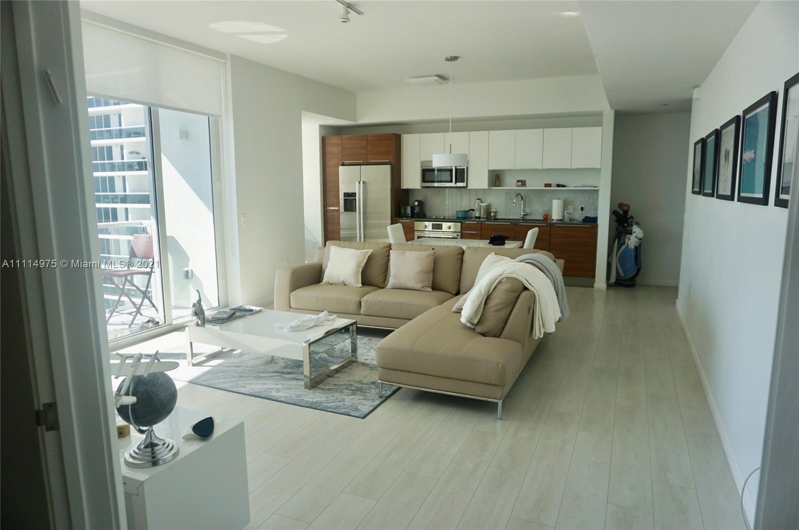601 Northeast 27th Street, Unit 1604 Miami, FL 33137 - Photo 15 of 47 a living room with furniture and a large window