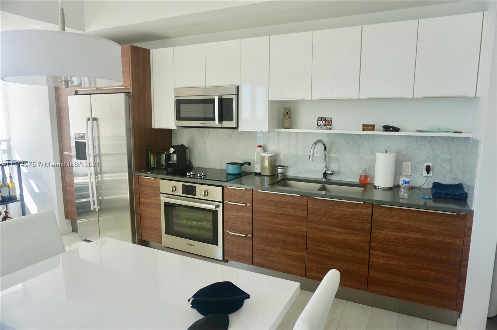 601 Northeast 27th Street, Unit 1604 Miami, FL 33137 - Photo 16 of 47 a kitchen with stainless steel appliances granite countertop a refrigerator sink and microwave