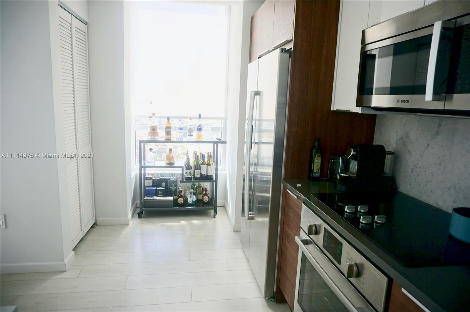 601 Northeast 27th Street, Unit 1604 Miami, FL 33137 - Photo 18 of 47 a kitchen with a sink and cabinets