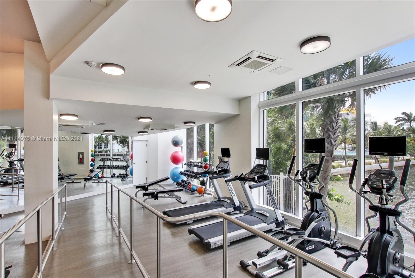 601 Northeast 27th Street, Unit 1604 Miami, FL 33137 - Photo 26 of 47 a room with gym equipment and large windows