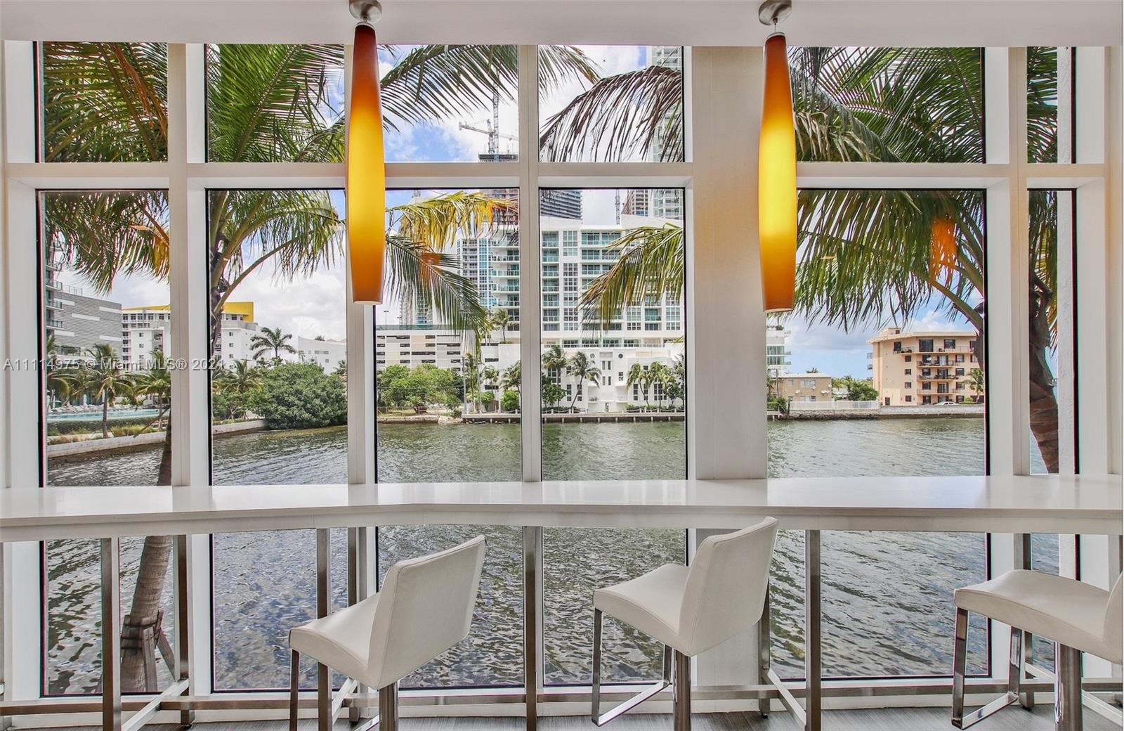 601 Northeast 27th Street, Unit 1604 Miami, FL 33137 - Photo 39 of 47 a view of a dining room with furniture water view and wooden floor