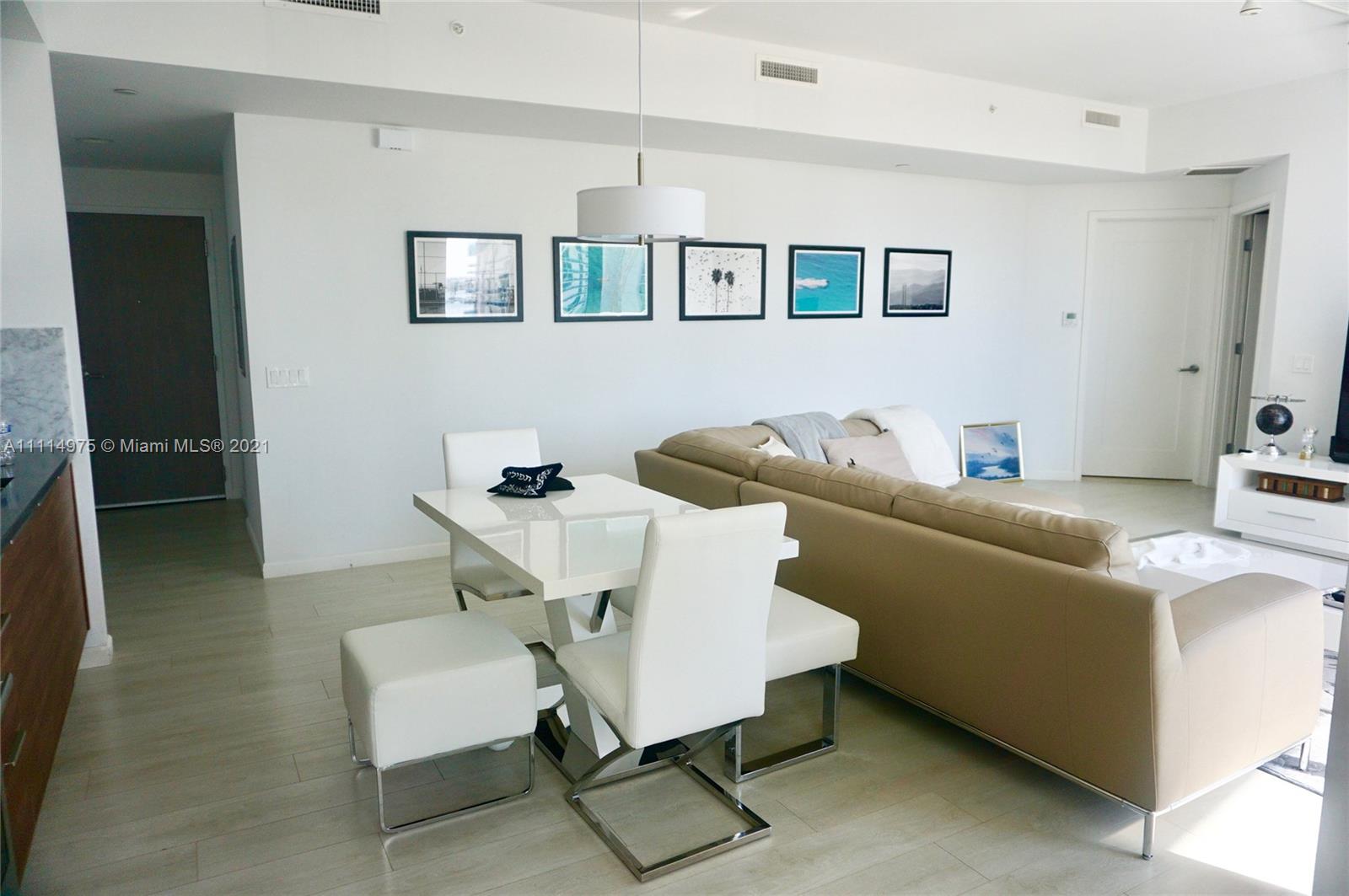 601 Northeast 27th Street, Unit 1604 Miami, FL 33137 - Photo 6 of 47 a living room with furniture and a potted plant