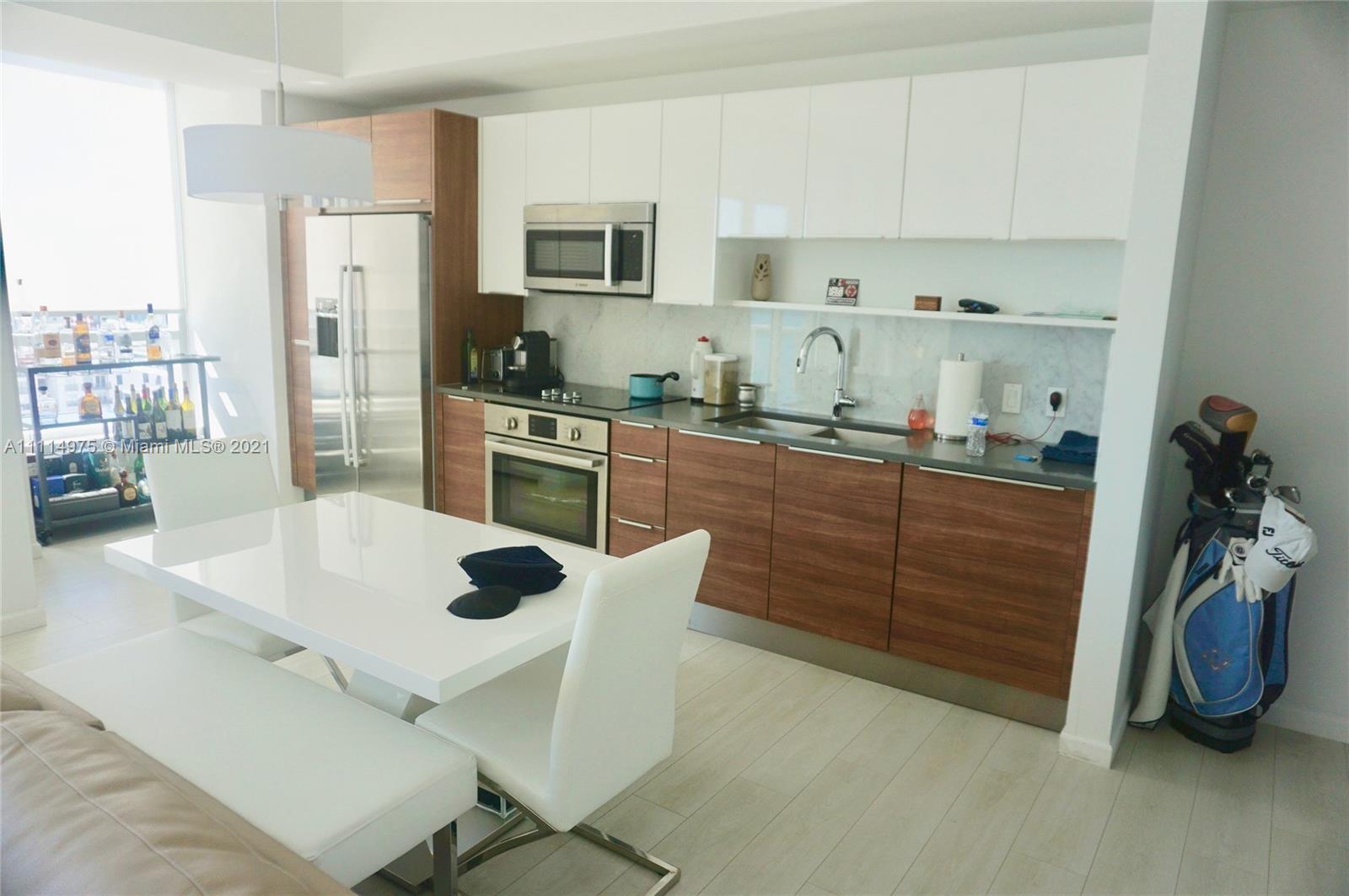601 Northeast 27th Street, Unit 1604 Miami, FL 33137 - Photo 7 of 47 a kitchen with stainless steel appliances a stove a sink a refrigerator and cabinets