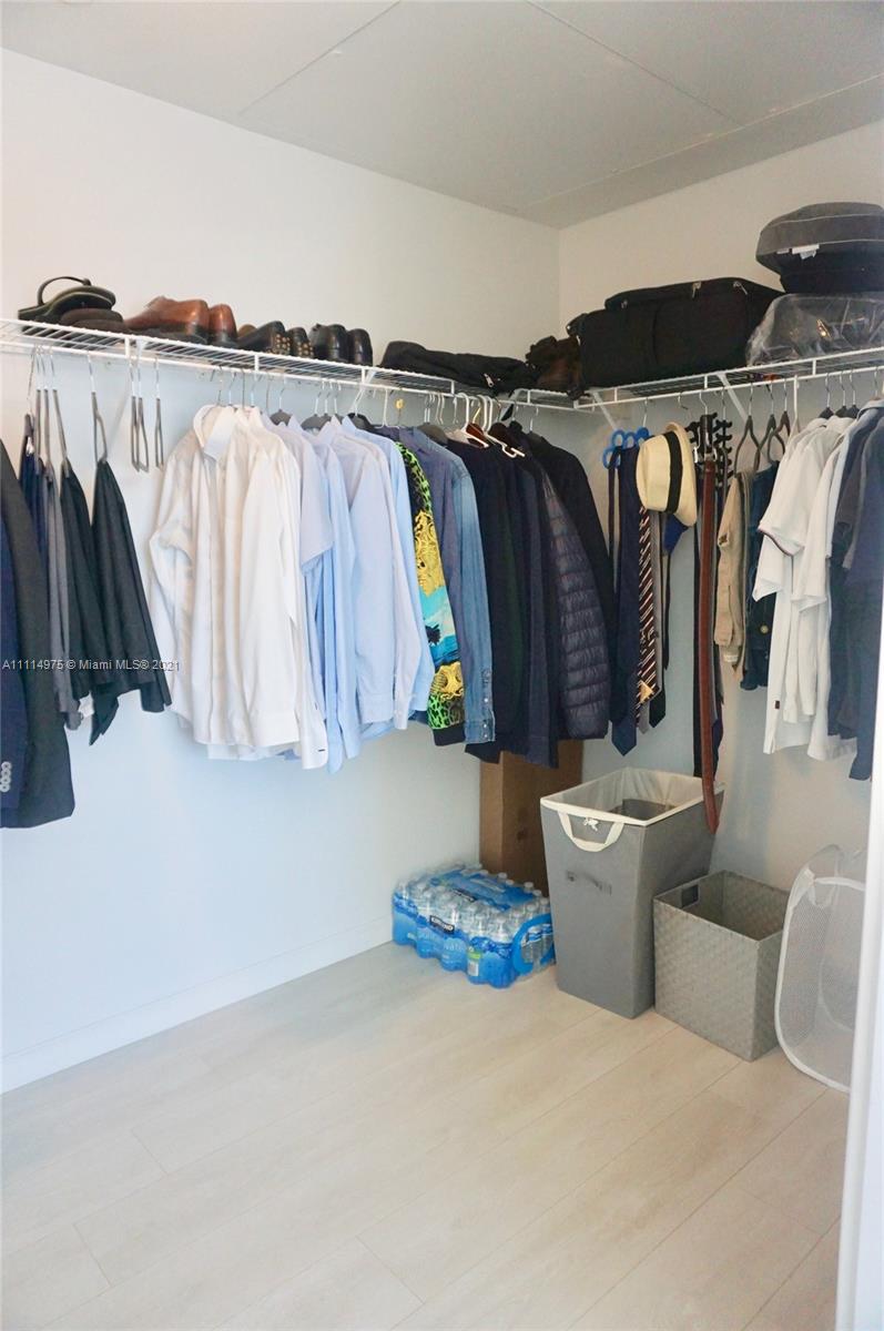 601 Northeast 27th Street, Unit 1604 Miami, FL 33137 - Photo 9 of 47 a view of walk in closet with clothes and shoes