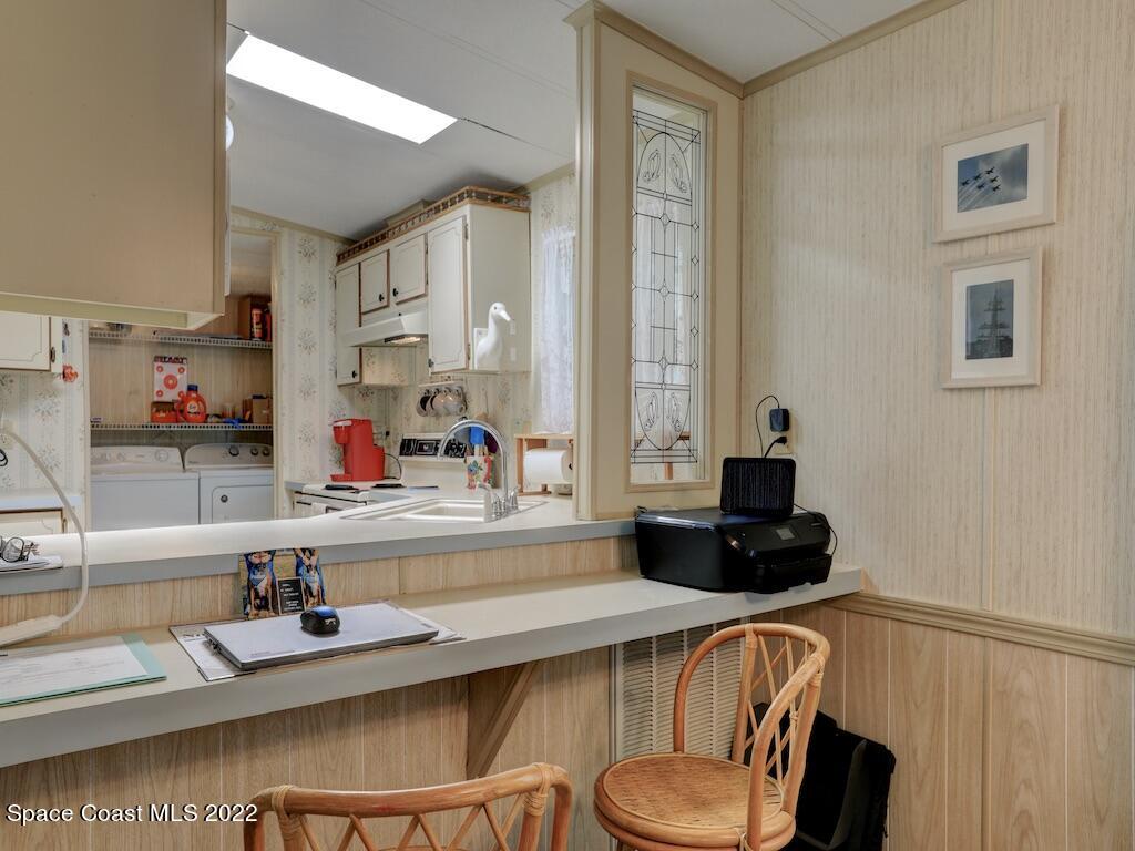 622 Wedelia Drive Sebastian, FL 32976 - Photo 14 of 29 a kitchen with a refrigerator a stove a sink and a cabinets
