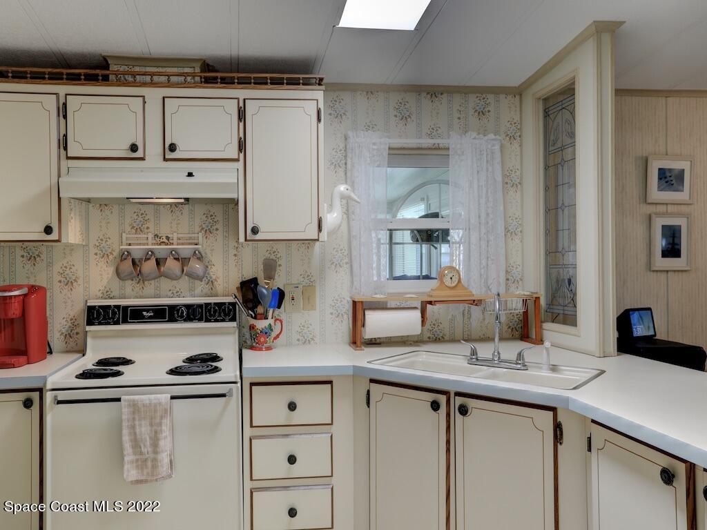 622 Wedelia Drive Sebastian, FL 32976 - Photo 15 of 29 a kitchen with stainless steel appliances granite countertop a sink stove and cabinets