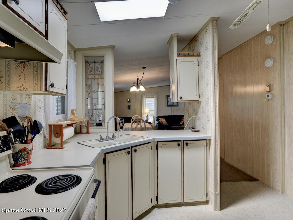 622 Wedelia Drive Sebastian, FL 32976 - Photo 16 of 29 a kitchen with a sink a stove and cabinets