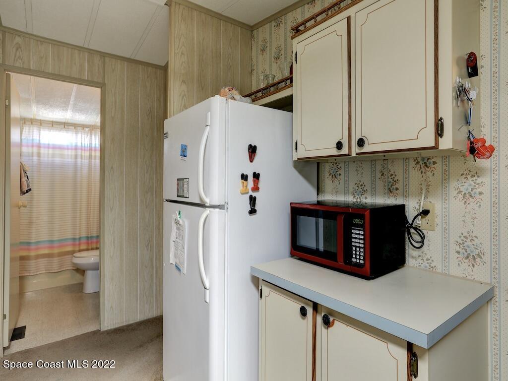 622 Wedelia Drive Sebastian, FL 32976 - Photo 17 of 29 a kitchen with stainless steel appliances a refrigerator and a stove