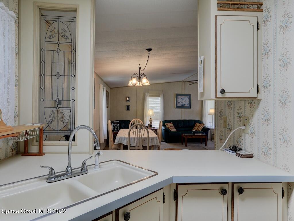 622 Wedelia Drive Sebastian, FL 32976 - Photo 18 of 29 a kitchen with a sink and a mirror