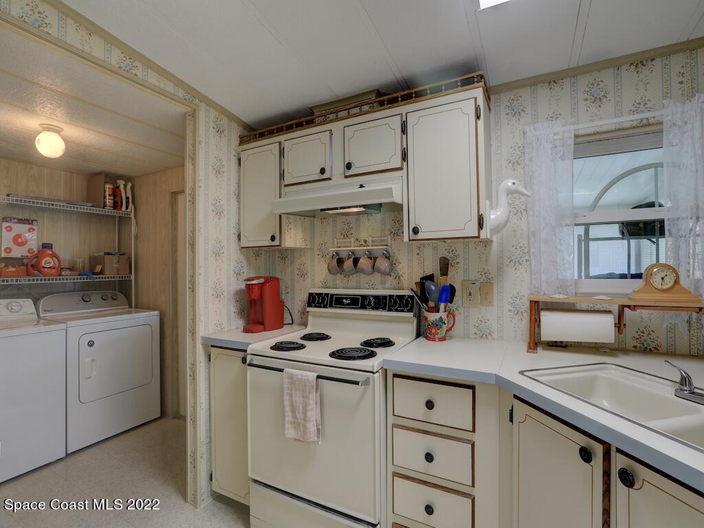 622 Wedelia Drive Sebastian, FL 32976 - Photo 19 of 29 a kitchen with white cabinets and white appliances