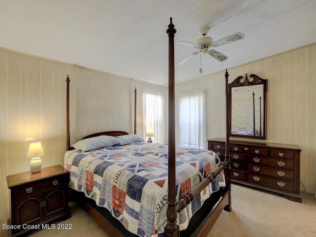 622 Wedelia Drive Sebastian, FL 32976 - Photo 20 of 29 a bedroom with a bed a lamp and a dresser