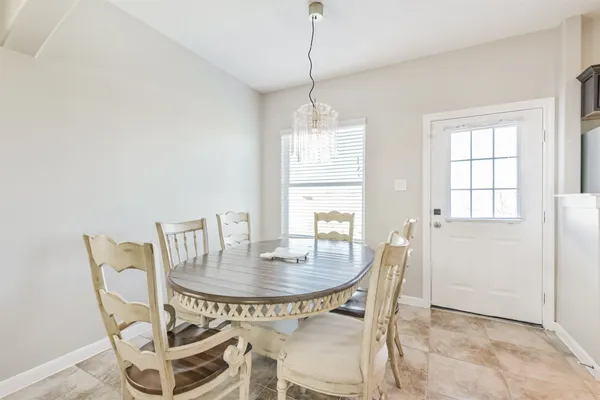 a dining room with furniture and window