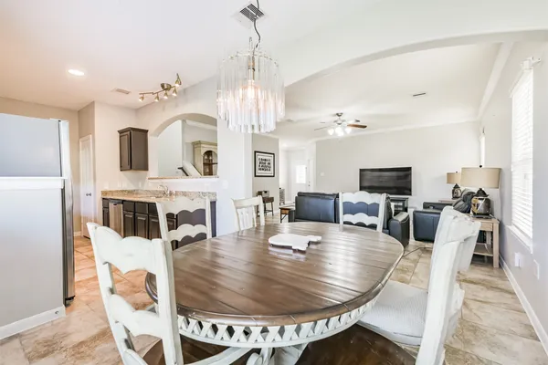 a view of a dining room with furniture and a chandelier