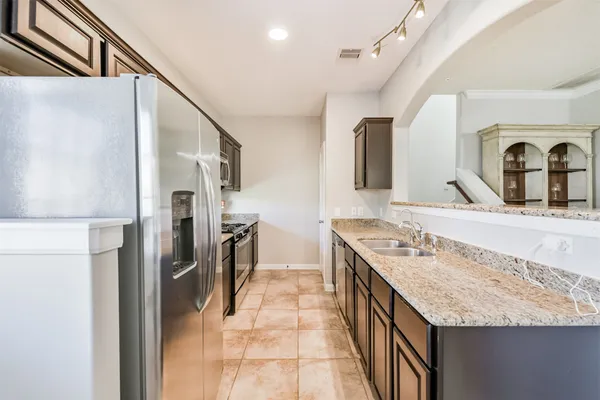 a kitchen with a sink stove and refrigerator