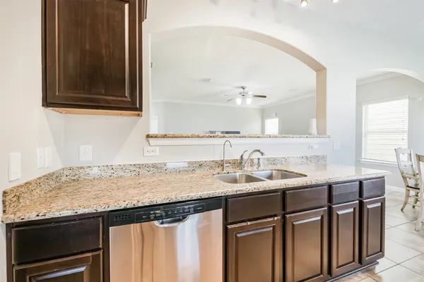 a bathroom with a granite countertop sink a mirror and a