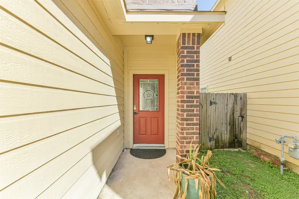 a view of a porch with a door and wooden floor