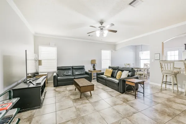 a living room with furniture and wooden floor
