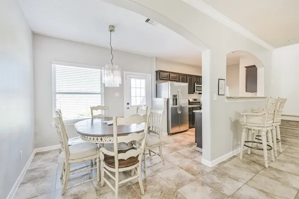 a dining room with furniture and window