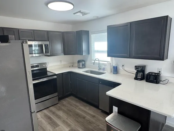 a kitchen with a sink cabinets and stainless steel appliances