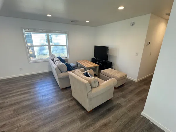 a living room with couches and a flat screen tv