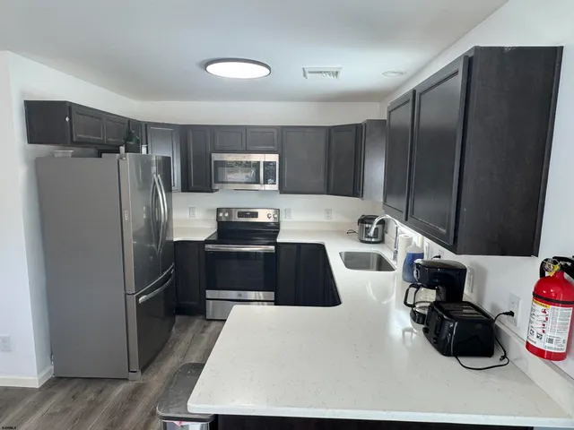 a kitchen with a refrigerator and a stove