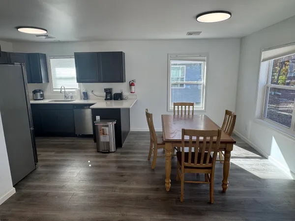 a view of a dining room with furniture and wooden floor