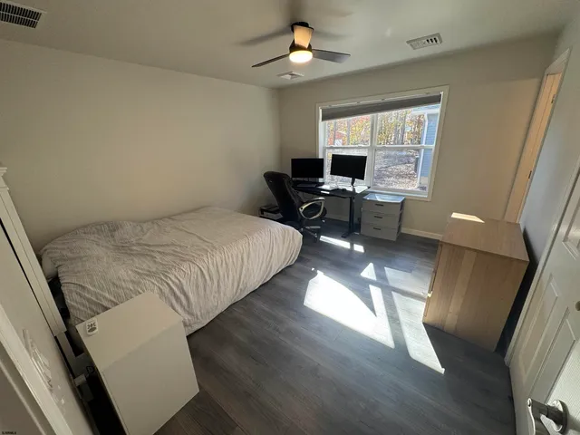 a bedroom with a bed a chair and a chandelier