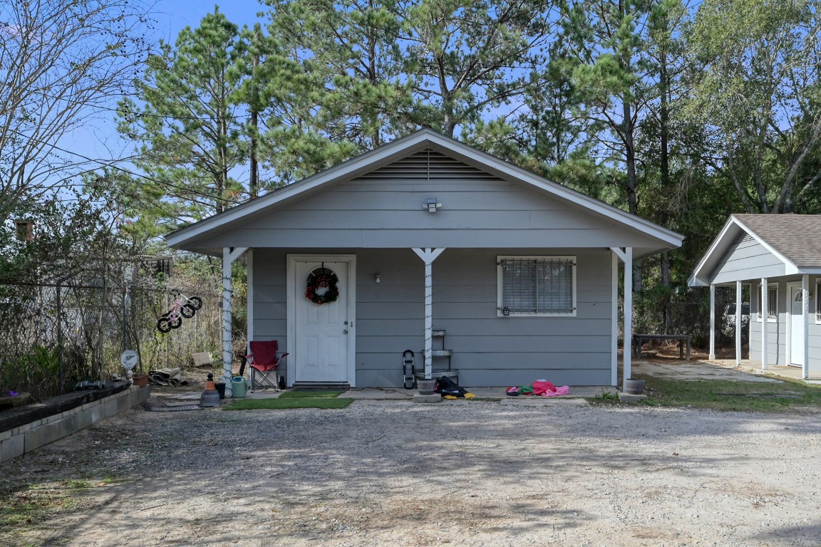 113 Cartwright Road Conroe, TX 77301 - Photo 1 of 15 a front view of a house with a yard