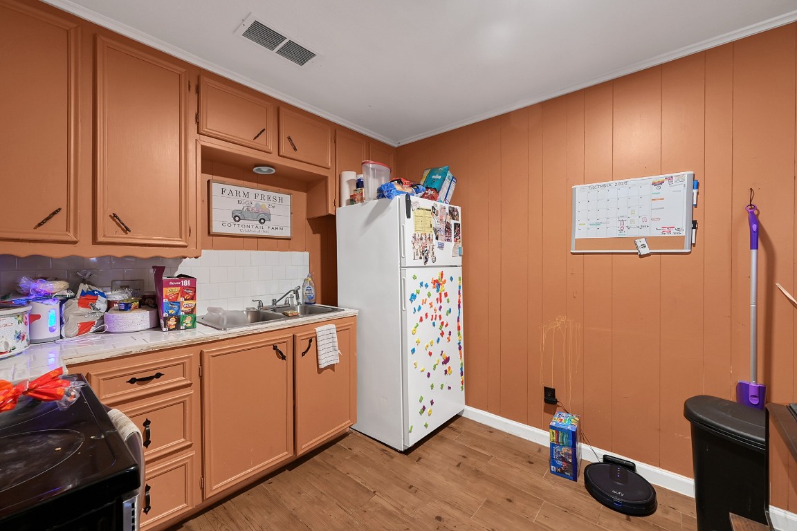 113 Cartwright Road Conroe, TX 77301 - Photo 2 of 15 a kitchen with stainless steel appliances a refrigerator and cabinets