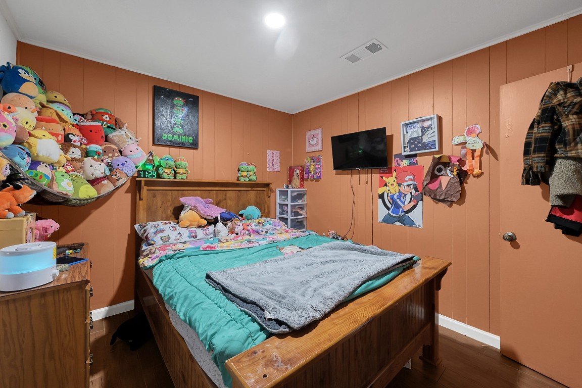 113 Cartwright Road Conroe, TX 77301 - Photo 6 of 15 a bedroom with a bed and a flat screen tv