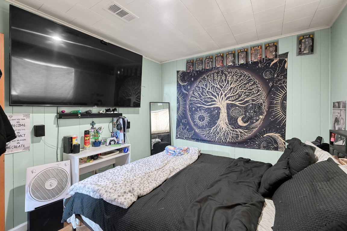 113 Cartwright Road Conroe, TX 77301 - Photo 8 of 15 a bedroom with furniture and a flat screen tv