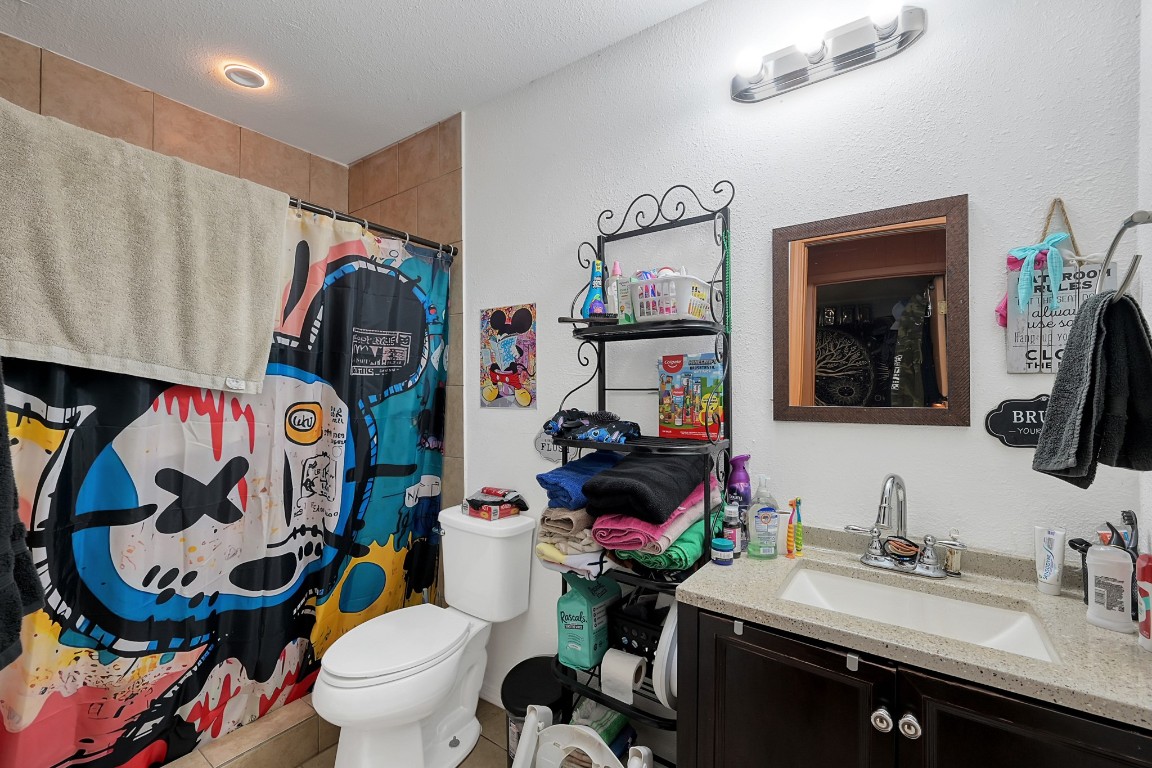 113 Cartwright Road Conroe, TX 77301 - Photo 9 of 15 a bathroom with a sink a toilet and a mirror