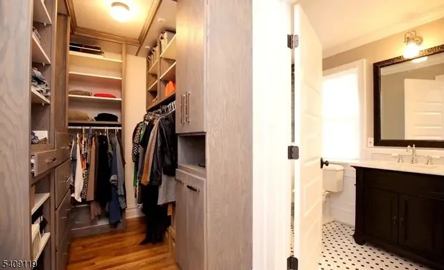 a view of walk in closet with clothes and shoes