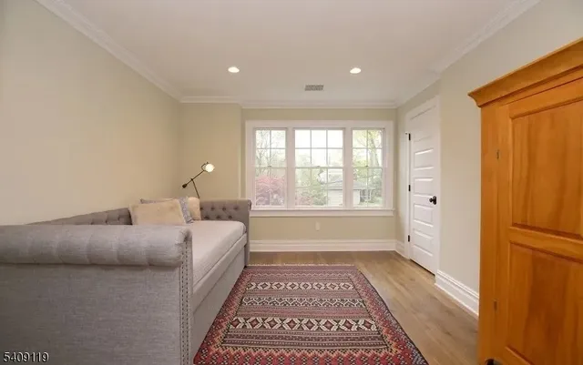 a spacious bedroom with a large bed and a rug