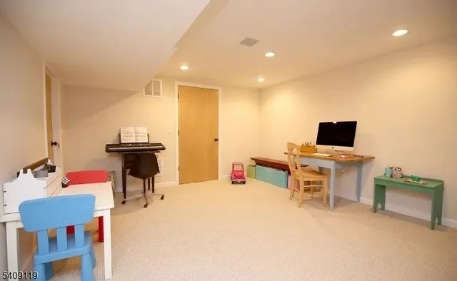 a bedroom with furniture and a flat screen tv