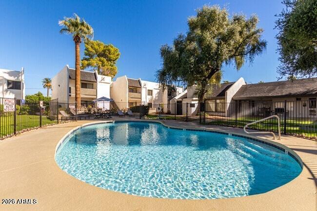 302 East Monte Vista Road, Unit A16 Phoenix, AZ 85004 - Photo 11 of 17 a view of a swimming pool with outdoor seating