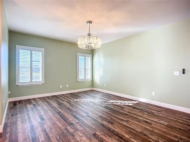 a view of a room with wooden floor and fan