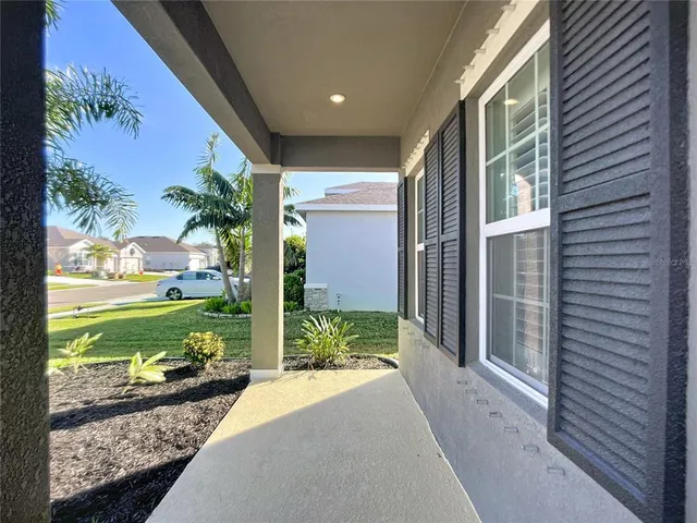 a view of a room with wooden floor lounge chair and windows