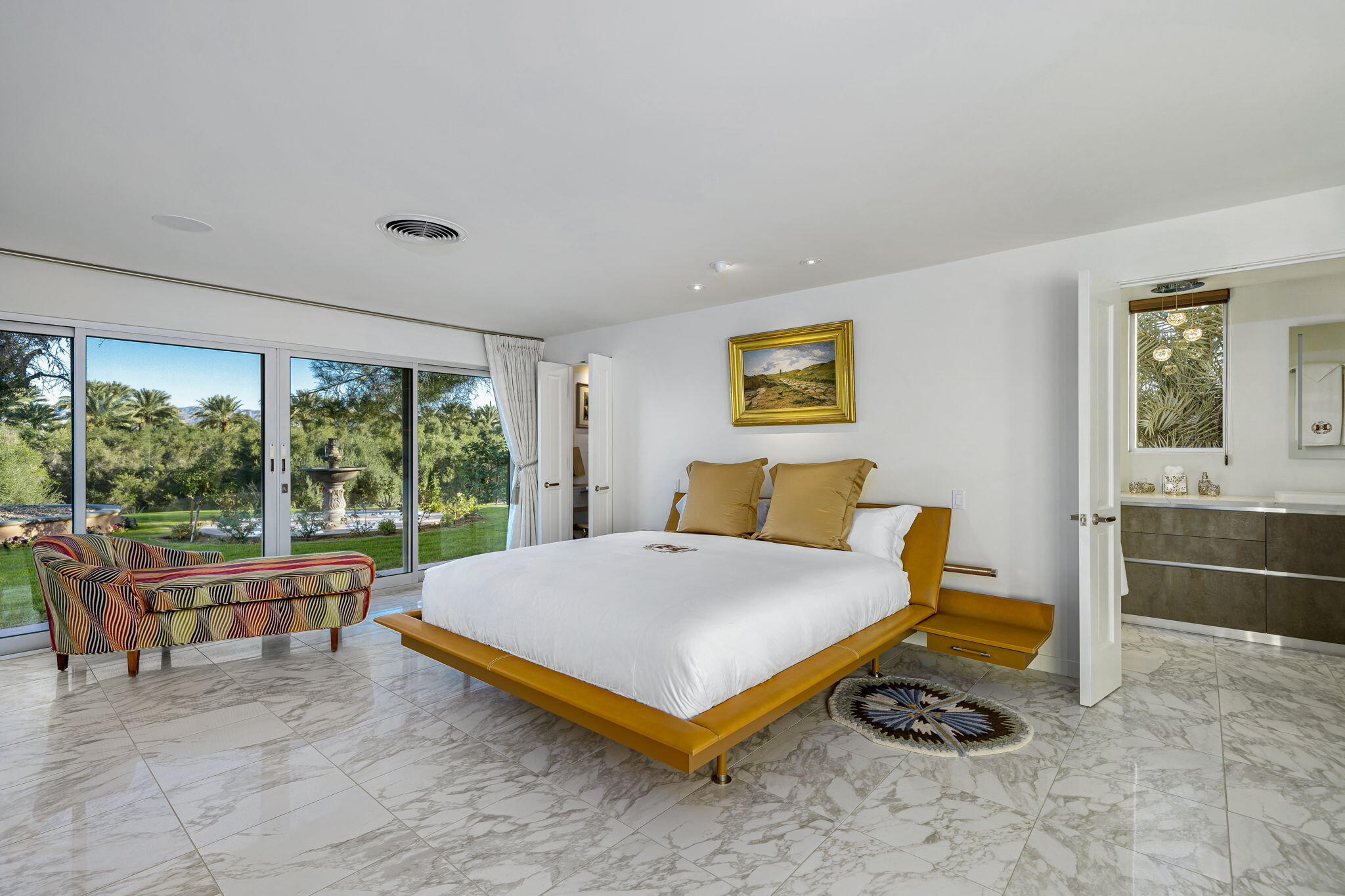 51555 Madison Street La Quinta, CA 92253 - Photo 12 of 25 a bedroom with a bed and large windows